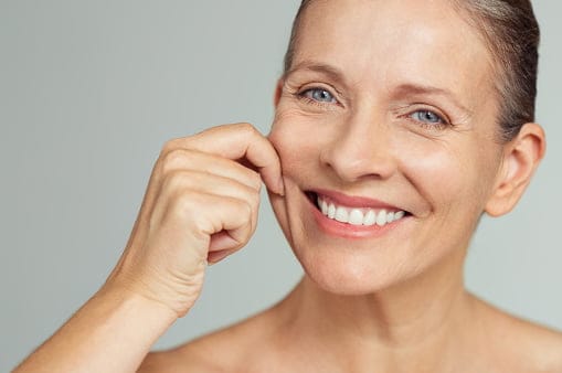 a person touching her cheek Diamond Polar Skin Tightening