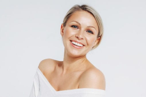 a person smiling at the camera Microoneedling